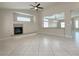 Bright living room showcasing tile floors, ceiling fan, and fireplace with views into the dining area at 33 Hatten Bay St, Henderson, NV 89012