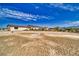 Expansive backyard with potential for landscaping and outdoor activities, under a bright, blue sky at 3301 Underbrush Ave, Pahrump, NV 89048