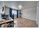 Spacious bedroom with wood floors, large window with blue curtains, and stylish desk setup at 3301 Underbrush Ave, Pahrump, NV 89048