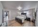A tranquil bedroom features wood-look floors, a platform bed, and an adjacent bathroom exudes calm sophistication at 3301 Underbrush Ave, Pahrump, NV 89048