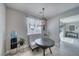 Bright breakfast nook with a round table, tufted bench, and views into the living room at 3301 Underbrush Ave, Pahrump, NV 89048