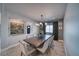 Elegant dining room with an eye-catching chandelier and a long table with seating for eight at 3301 Underbrush Ave, Pahrump, NV 89048
