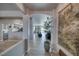 Inviting entryway with arched openings leads to open-concept kitchen and living areas and features tile flooring at 3301 Underbrush Ave, Pahrump, NV 89048