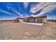 Single-story home with a neutral color scheme, three-car garage, and desert landscaping at 3301 Underbrush Ave, Pahrump, NV 89048