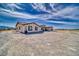 Front exterior view of a single-story home with a three-car garage and desert landscaping at 3301 Underbrush Ave, Pahrump, NV 89048
