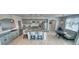 Bright kitchen featuring stainless appliances, an island with bar stool seating, and an adjacent table with upholstered bench at 3301 Underbrush Ave, Pahrump, NV 89048