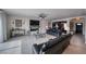 Spacious living room boasts tile flooring, a fireplace, and a ceiling fan and offers access to the entry at 3301 Underbrush Ave, Pahrump, NV 89048