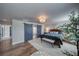 Stylishly appointed main bedroom with barn door, chandelier, seating, and wood-look floors at 3301 Underbrush Ave, Pahrump, NV 89048