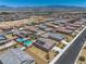 Overhead view showing a neighborhood with backyard pools, patios, and neat landscaping amid mountain views at 3568 E Malheur Ave, Pahrump, NV 89061