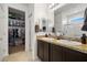 Bathroom with dual sinks, granite countertops, and a large walk-in closet for convenient storage at 3568 E Malheur Ave, Pahrump, NV 89061