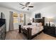 Cozy bedroom with a ceiling fan, dresser, a comfortable bed, and serene natural light from the window at 3568 E Malheur Ave, Pahrump, NV 89061