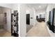 Bright hallway with tiled floors leads to a cozy living room and bathroom, offering a seamless transition at 3568 E Malheur Ave, Pahrump, NV 89061