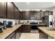 Spacious kitchen features granite counters, modern appliances, and plenty of dark cabinetry for storage at 3568 E Malheur Ave, Pahrump, NV 89061