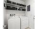 Organized laundry room equipped with modern washer and dryer units, complemented by ample shelving space at 3568 E Malheur Ave, Pahrump, NV 89061