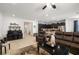 Open-concept living area showcasing a brown sofa, dark kitchen cabinets, and an eat-in kitchen island at 3568 E Malheur Ave, Pahrump, NV 89061