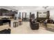Open-concept living space featuring tile flooring, a modern kitchen, dining area, and comfortable seating at 3568 E Malheur Ave, Pahrump, NV 89061