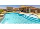 A beautiful in-ground pool featuring an attached spa, tanning deck, and covered outdoor living area at 3568 E Malheur Ave, Pahrump, NV 89061