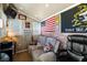 Interior shot of a shed set up as a recreational space with a TV, sofa, and a patriotic theme at 3568 E Malheur Ave, Pahrump, NV 89061