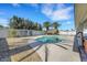 Backyard with gravel landscaping, pool, mature trees and a covered patio area offering relaxation at 3746 E Harmon Ave, Las Vegas, NV 89121