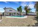 Backyard with gravel landscaping, pool, hot tub, covered patio, and a lush palm tree at 3746 E Harmon Ave, Las Vegas, NV 89121