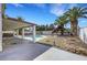 Expansive backyard featuring a pool, hot tub, covered patio, and lush palm trees offering relaxation at 3746 E Harmon Ave, Las Vegas, NV 89121