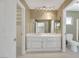 Bright bathroom featuring dual sinks with a large mirror, recessed lighting, and tiled flooring at 3746 E Harmon Ave, Las Vegas, NV 89121