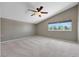 Spacious bedroom featuring neutral carpet, a ceiling fan, a window, and a vaulted ceiling at 3746 E Harmon Ave, Las Vegas, NV 89121