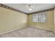 Bedroom featuring neutral carpet, a ceiling fan, a window, and decorative wallpaper border at 3746 E Harmon Ave, Las Vegas, NV 89121