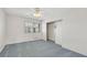 Bedroom with neutral carpet, a ceiling fan, and a window offering natural light at 3746 E Harmon Ave, Las Vegas, NV 89121