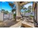 Charming courtyard featuring a decorative iron gate, gravel, and mature trees for added privacy at 3746 E Harmon Ave, Las Vegas, NV 89121