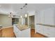The kitchen has an island with granite counters and sleek white cabinetry at 3746 E Harmon Ave, Las Vegas, NV 89121
