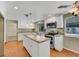 Kitchen with island, granite counters, white cabinets, and modern appliances at 3746 E Harmon Ave, Las Vegas, NV 89121