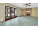 Living room boasts brick fireplace, tiled floors, and glass doors to the outside at 3746 E Harmon Ave, Las Vegas, NV 89121