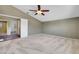 Large bedroom featuring neutral carpet, a ceiling fan, and access to the ensuite bathroom at 3746 E Harmon Ave, Las Vegas, NV 89121