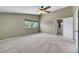 Spacious main bedroom featuring neutral carpet, a ceiling fan, and natural light from a window at 3746 E Harmon Ave, Las Vegas, NV 89121