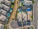 An aerial view features modern homes with private pools, manicured lawns, and desert landscaping in a neatly arranged community at 389 Red Feather Peak Ct, Las Vegas, NV 89138