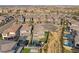Expansive aerial view of a modern home community with lush backyards, pools, and desert landscaping at 389 Red Feather Peak Ct, Las Vegas, NV 89138