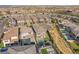 An aerial view shows houses with pools, green lawns, and desert landscaping, creating a beautiful outdoor living space at 389 Red Feather Peak Ct, Las Vegas, NV 89138