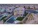 Aerial view of a home with a swimming pool, manicured lawn, and outdoor entertaining area at 389 Red Feather Peak Ct, Las Vegas, NV 89138