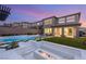 Modern backyard featuring a pool, outdoor lounge, fire pit, and manicured landscaping at 389 Red Feather Peak Ct, Las Vegas, NV 89138
