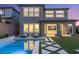 Beautiful home exterior showcasing a private backyard with a pool and lounge chairs at 389 Red Feather Peak Ct, Las Vegas, NV 89138