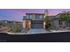 A modern two-story home with a gray facade, featuring a well-maintained driveway and manicured landscaping at 389 Red Feather Peak Ct, Las Vegas, NV 89138