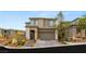 Beautiful two-story home with manicured landscaping and a two-car garage at 389 Red Feather Peak Ct, Las Vegas, NV 89138