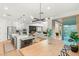 Open-concept kitchen with stainless steel appliances and a breakfast bar, seamlessly connecting to the living area and backyard access at 389 Red Feather Peak Ct, Las Vegas, NV 89138