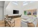 Open living room with high ceilings, modern furniture, and a view to the backyard at 389 Red Feather Peak Ct, Las Vegas, NV 89138