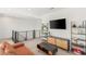 Well-lit loft area offers comfortable seating, modern shelving, and views of the home's open floor plan at 389 Red Feather Peak Ct, Las Vegas, NV 89138