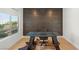 Home office with wood accent wall, modern desk and chair, and natural light at 389 Red Feather Peak Ct, Las Vegas, NV 89138