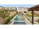 Stunning backyard with a sparkling pool, lush landscaping, and an outdoor kitchen at 389 Red Feather Peak Ct, Las Vegas, NV 89138