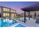 Stunning backyard oasis with a modern pool, spa, and covered patio for entertaining guests at 389 Red Feather Peak Ct, Las Vegas, NV 89138