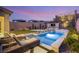 Inviting pool area with lush landscaping, lounge chairs, and an outdoor kitchen at 389 Red Feather Peak Ct, Las Vegas, NV 89138